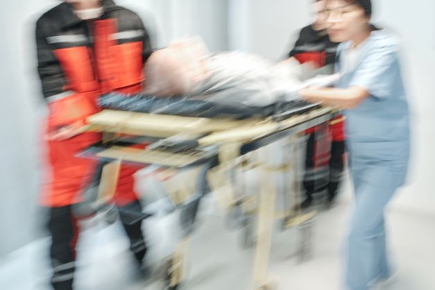 Ambulatory and healthcare worker bringing patient to emergency departmen on stretcher