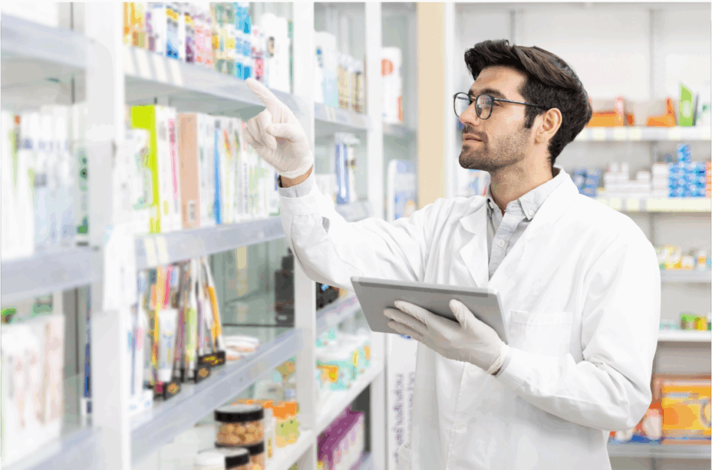 Pharmacy staff logging medication in storage room.