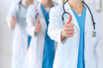 Team of healthcare workers with thumbs up.