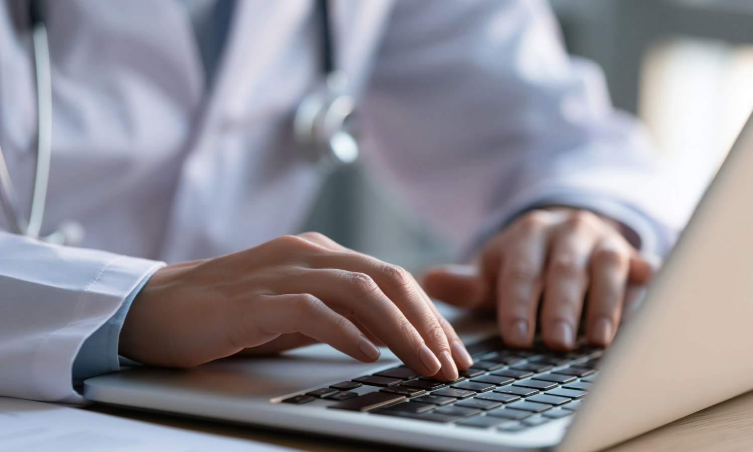 Healthcare worker typing a sentinel event report