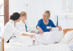 Nurses observing training for care of a patient.