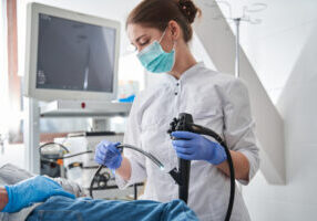 Surgeon using endoscope for surgical procedure.